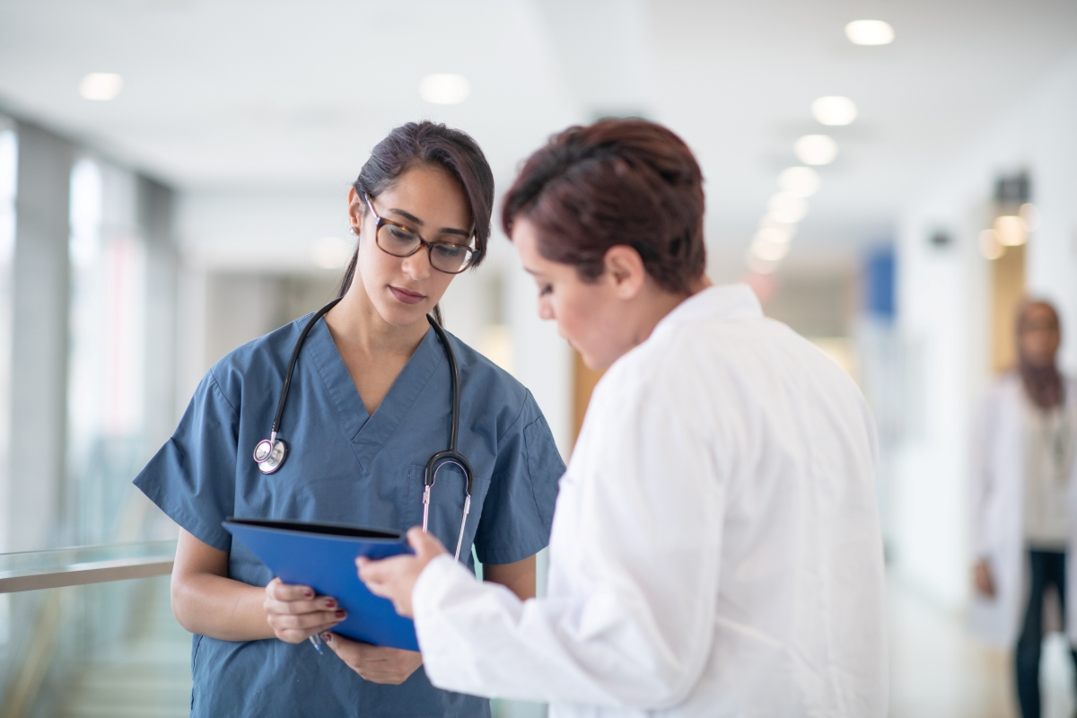 A Nurse Educator Talks With a Group of Student Nurses