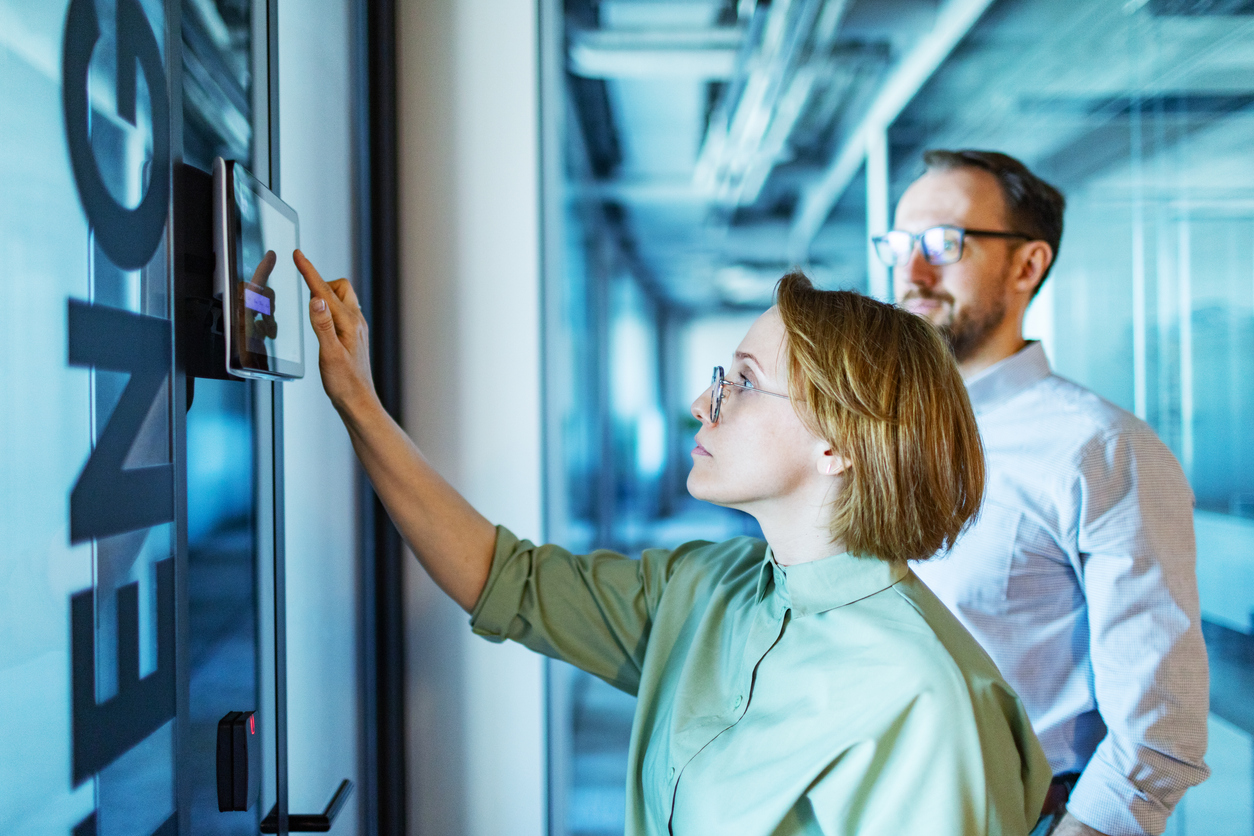 Professionals Using a Tablet to Access a Conference Room..jpg